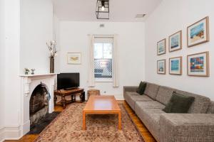 ein Wohnzimmer mit Couch und Kamin in der Unterkunft Captain's Heritage Cottage - central Fremantle 2 bedroom historic cottage in Fremantle
