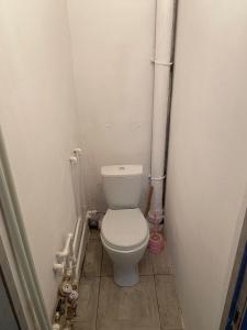 a small bathroom with a toilet and pipes at Гагарина 34 рядом с автовокзалом in Oral