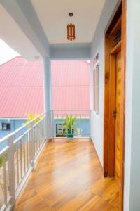 a hallway of a house with a balcony at Mangi Mangi Accomodation in Nungwi +4 photos