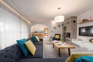 a living room with a blue couch and a table at Family villa Filton with wellness in Vizinada in Vranje Selo