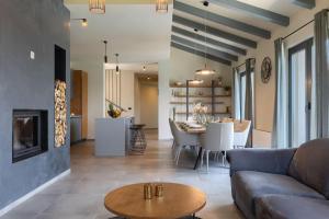 a living room with a couch and a table at Modern villa Lukas with pool in Vizinada in Vranje Selo