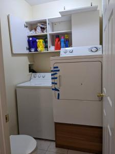 a bathroom with a washing machine and a washer at Cozy room at great Townhouse in Williamsburg in Brooklyn