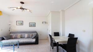 a living room with a couch and a table at Corinto 2428 in La Mata