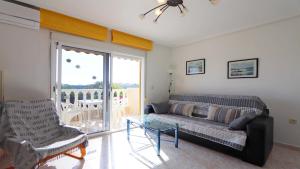 a living room with a couch and a glass table at Corinto 2428 in La Mata