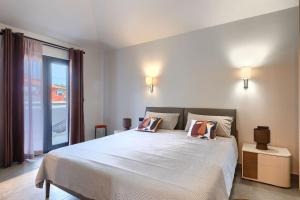 a bedroom with a bed with two pillows on it at Family villa Maria with pool in Vizinada in Vranje Selo +31 photos