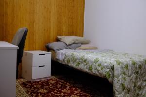 a bedroom with a bed with a dresser and a night stand at Comodo appartamento in Baranzate