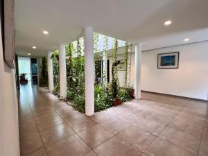 a hallway with columns and plants in a building at Residence ACHENBACH in Abidjan