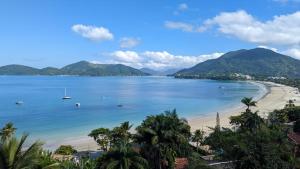 a view of a beach with boats in the water at Catalina Hotel in Ubatuba