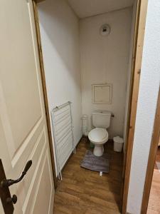 a small bathroom with a toilet in a room at Les 3 Vallées - Hameau des eaux d'Orelle - Appartement 003 in Orelle