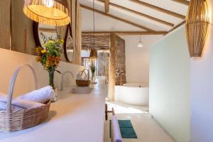 a bathroom with a bath tub and a sink at Casa Nuhatê Trancoso - Praia do Espelho in Praia do Espelho