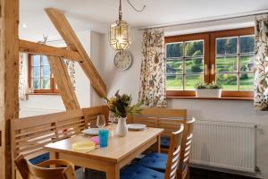 a dining room with a table and chairs and windows at Haus Löwen in Forbach