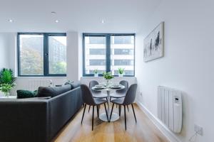 a living room with a couch and a table at NEW! Stylish 2-bed apartment in Manchester by 53 Degrees Property - Amazing location, Ideal for Small Groups - Sleeps 4! in Manchester