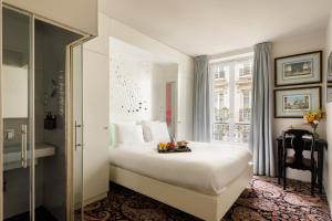 a hotel room with a bed and a window at Albert's Hotel in Paris