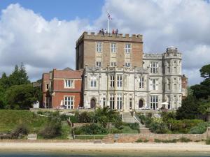 an old castle with people on top of it at The Gables Penthouse in Poole