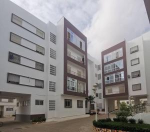 a large white building with balconies on it at Nadushka Voyage appartement in Agadir in Agadir