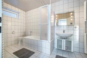 a white bathroom with a sink and a toilet at Ferienwohnung Große in Osterode +14 photos