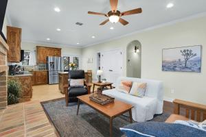 a living room with a couch and a ceiling fan at Deer Haus Retreat in New Braunfels