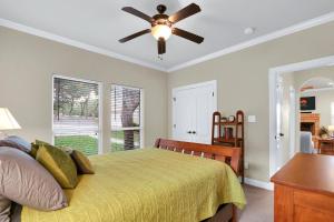a bedroom with a bed and a ceiling fan at Deer Haus Retreat in New Braunfels