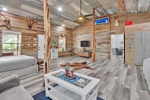 a living room with a bed and a couch and a table at Bulverde Cottage at Moonlight Getaway in Bulverde
