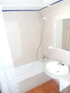 a bathroom with a sink and a tub and a toilet at 2 bedrooms appartement at Ciutadella de Menorca 200 m away from the beach with shared pool and enclosed garden in Cala en Bosc