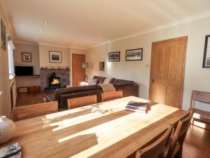 a living room with a table and a couch at Foresters Cottage in Rusland