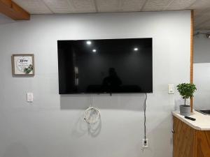 a flat screen tv hanging on a white wall at Basic 3 bedroom in Trenton with trailer parking in Trenton
