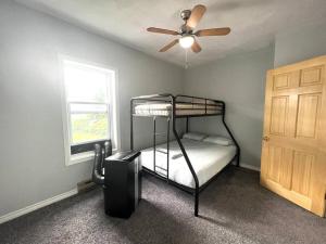 a bedroom with a bunk bed and a ceiling fan at Basic 3 bedroom in Trenton with trailer parking in Trenton