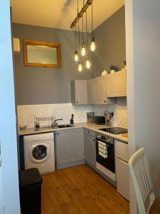 a kitchen with a sink and a dishwasher at Stylish One bed apartment in Inverness