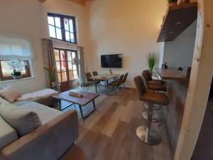 a living room with a couch and a table at Hochalmbahnen Chalets Rauris 1-13 WE 3, Maislaufeldweg 1m OG in Rauris