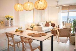 a living room with a table and chairs at Almuñecar Seawiews Deluxe SinEsedesignhomes in Almuñécar