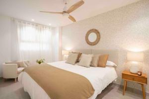 a bedroom with a large bed and a ceiling fan at Almuñecar Seawiews Deluxe SinEsedesignhomes in Almuñécar +35 photos