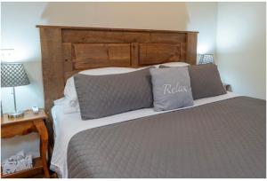 a bed with a wooden headboard in a bedroom at Mockingbird Mountain Spa and Retreat in Luray