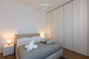 a bedroom with a bed with two towels on it at La casa di GABRIELLA in Milan +42 photos