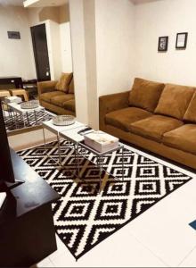a living room with a couch and a table at Cosmo Residence “ 1 BR ” at Thamrin City in Jakarta