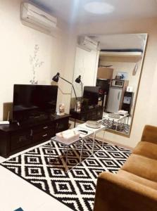 a living room with a black and white rug at Cosmo Residence “ 1 BR ” at Thamrin City in Jakarta