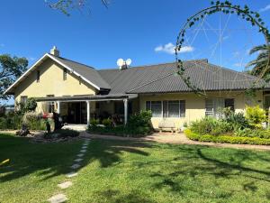 a house with a metal roof and a yard at Homestead Bed and Breakfast in Addo