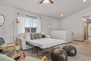 a living room with a couch and a table at Hill's View Retreat on the Edge of the Prairie in Rapid City