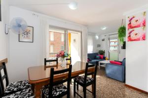 a dining room and living room with a table and chairs at Apartamento Disa in Lloret de Mar