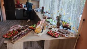a table with many different types of food on it at CABANA ADAM SI EVA in Gura Râului +8 photos