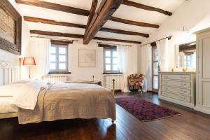 a bedroom with a large bed and wooden ceilings at Rustic villa Amyra with pool and grill in Porec in Sveti Lovreč Pazenatički +26 photos