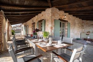 a dining room with a table and chairs on a patio at Rustic villa Amyra with pool and grill in Porec in Sveti Lovreč Pazenatički