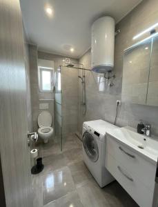 a bathroom with a washing machine and a sink at Villa Felicita in Trogir