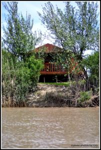 a house sitting on the bank of a river at Goshen Guest Farm in Edenburg