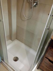 a shower with a drain in the middle at Tourist Rental Home ROMA in Rome