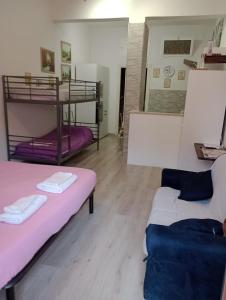 a room with two bunk beds and a couch at Tourist Rental Home ROMA in Rome