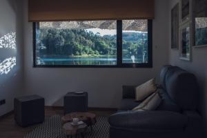 a living room with a couch and a large window at Beche EcoCamp in Santa Eulalia