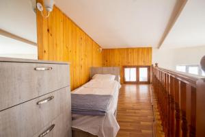 two beds in a room with wooden walls at Center Apartment 3 Rooms in Tbilisi City
