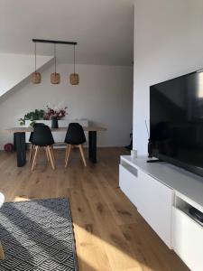 a living room with a large television and a table at Wolu Room in Brussels