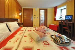 a bedroom with a large bed with a tray on it at L'Ancien Paquier Chambre D'Hotes in Valtournenche