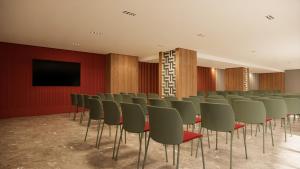 a conference room with chairs and a flat screen tv at Occidental Pamplona in Pamplona